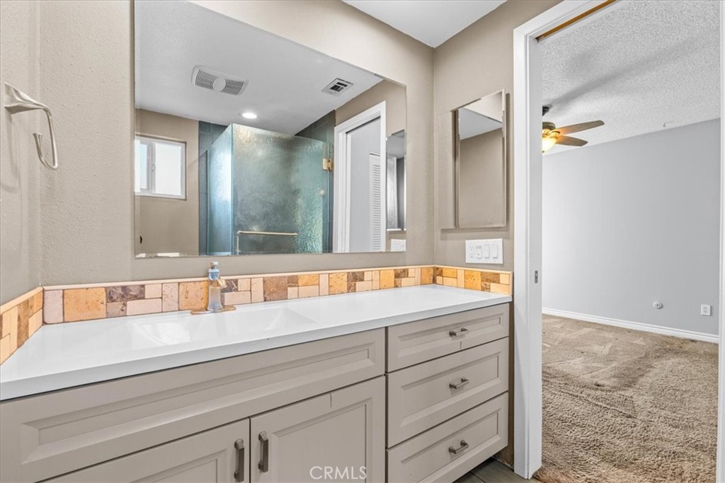 6240 Wiehe Avenue Riverside, CA 92506 - Photo 21 of 47 a bathroom with a granite countertop sink mirror and double