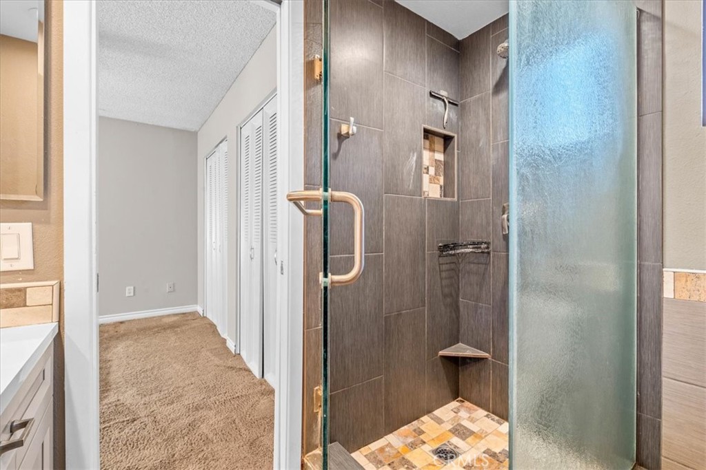 6240 Wiehe Avenue Riverside, CA 92506 - Photo 22 of 47 a bathroom with a glass shower door