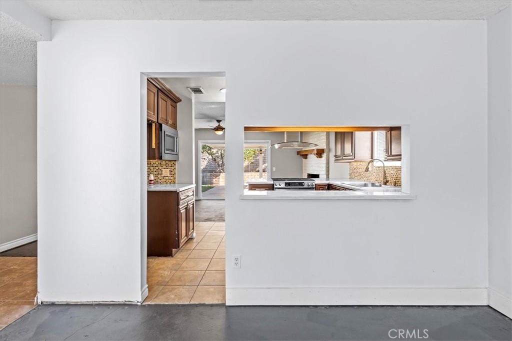 6240 Wiehe Avenue Riverside, CA 92506 - Photo 8 of 47 a living room with stainless steel appliances kitchen island granite countertop a refrigerator and a stove top oven
