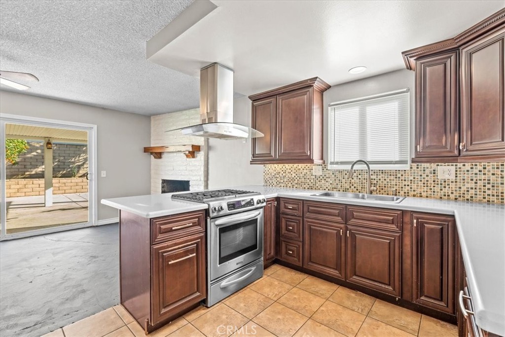 6240 Wiehe Avenue Riverside, CA 92506 - Photo 9 of 47 a kitchen with a stove sink and cabinets