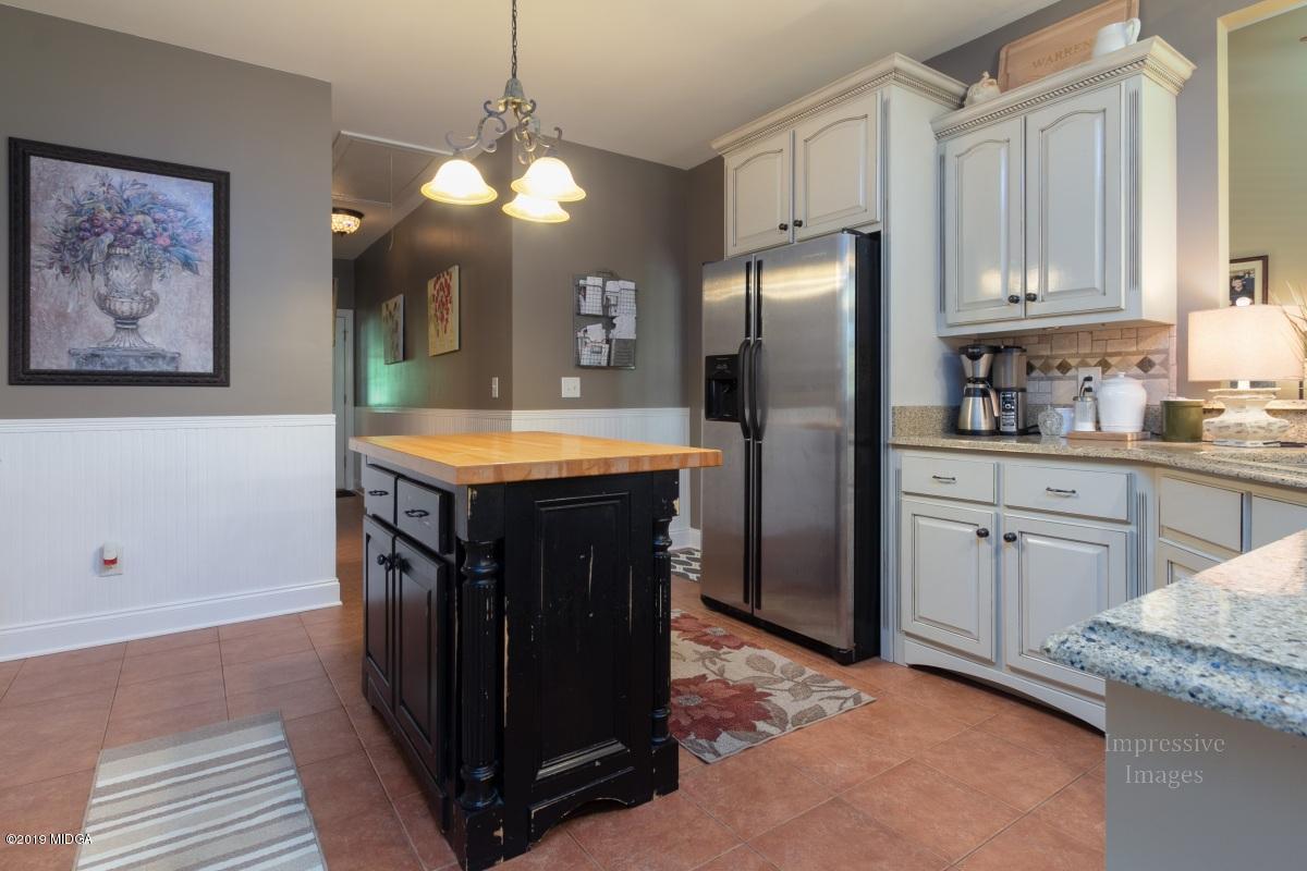 800 Pine Grove Church Road Culloden, GA 31016 - Photo 11 of 30 a kitchen with kitchen island granite countertop a sink stove and refrigerator