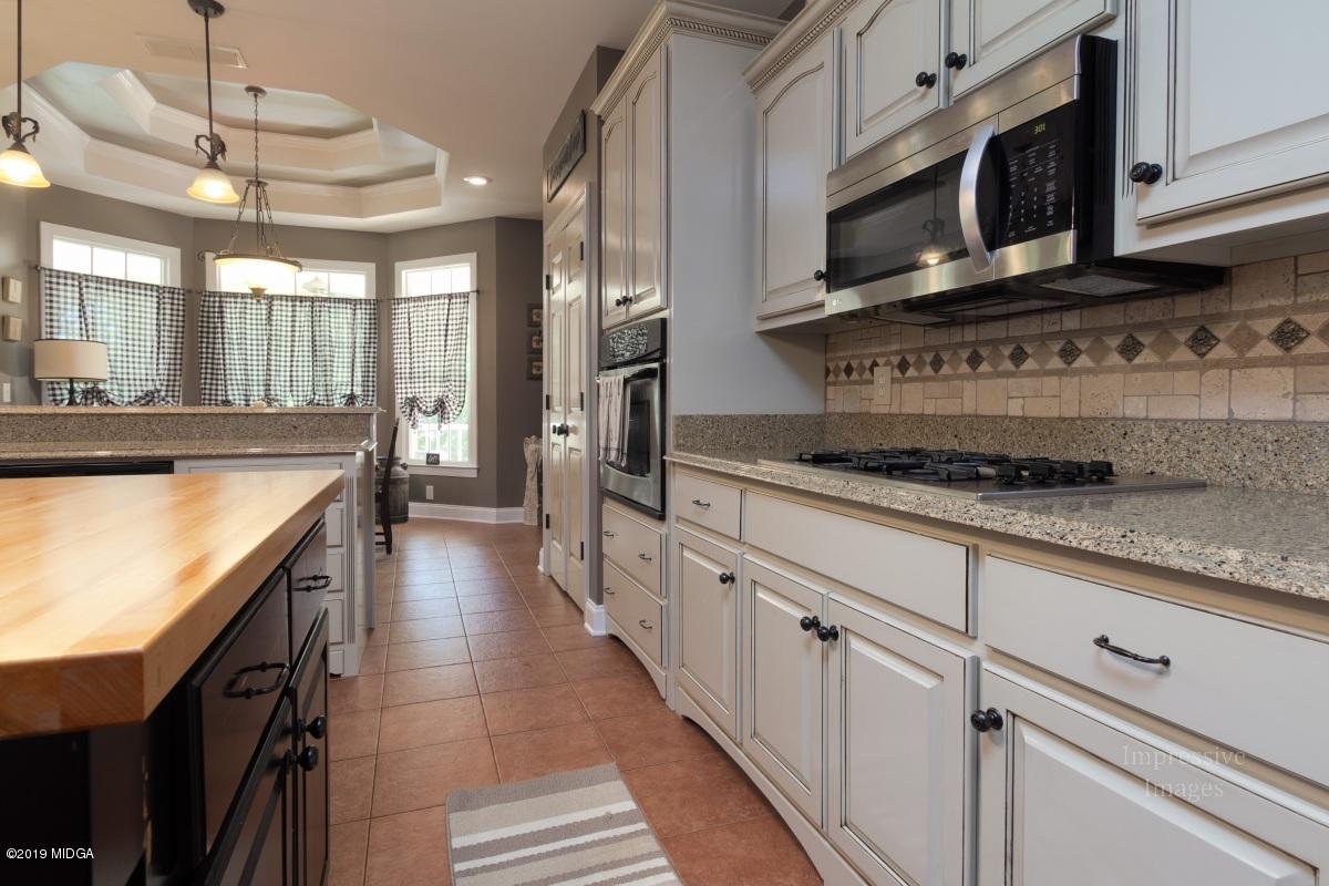 800 Pine Grove Church Road Culloden, GA 31016 - Photo 12 of 30 a kitchen with stainless steel appliances granite countertop a sink and a stove