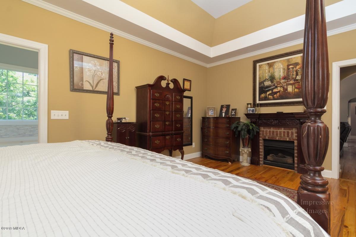 800 Pine Grove Church Road Culloden, GA 31016 - Photo 14 of 30 a bedroom with a bed dresser and a flat tv screen