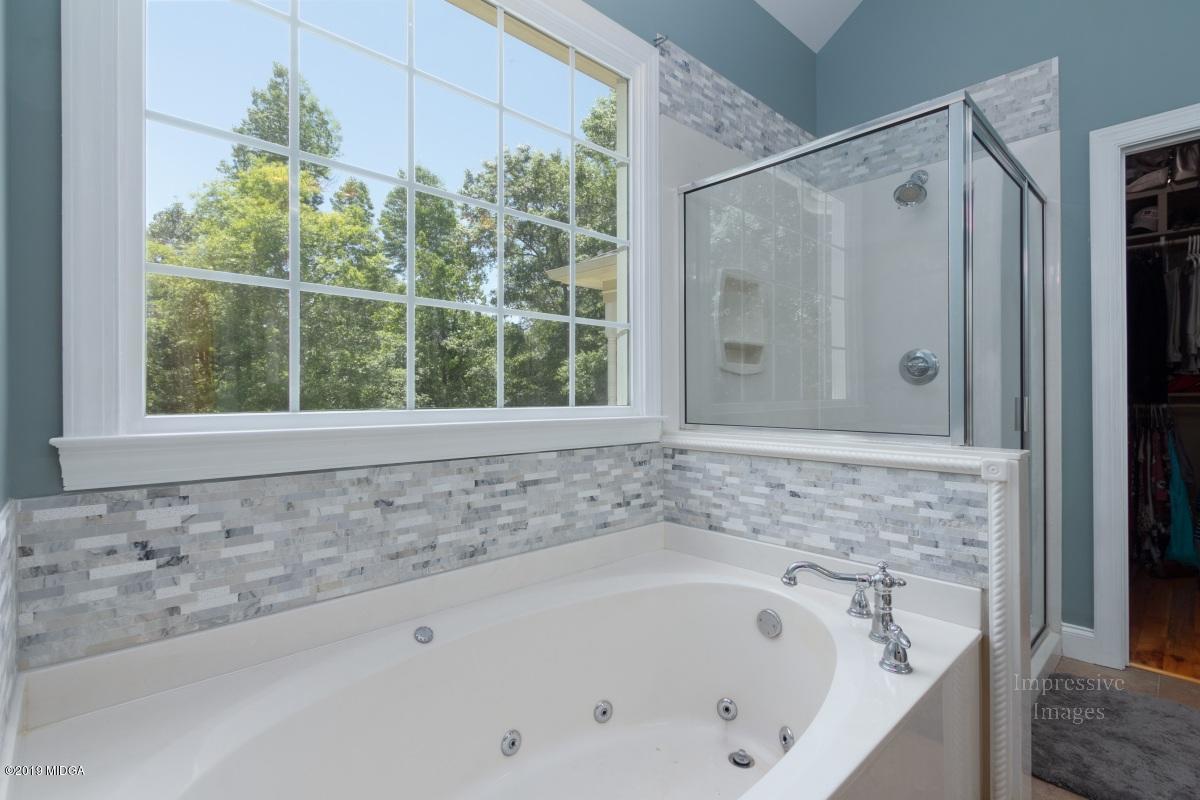 800 Pine Grove Church Road Culloden, GA 31016 - Photo 16 of 30 a bathroom with a bathtub and shower