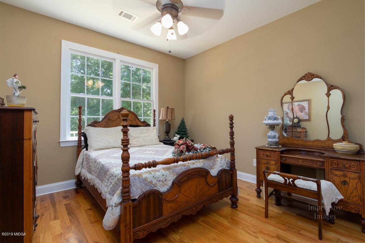 800 Pine Grove Church Road Culloden, GA 31016 - Photo 20 of 30 a bedroom with a bed and wooden floor