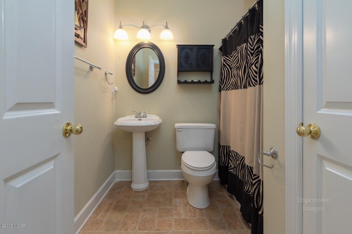 800 Pine Grove Church Road Culloden, GA 31016 - Photo 24 of 30 a bathroom with a toilet sink and mirror
