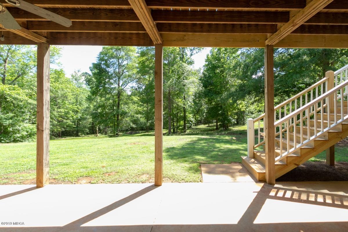 800 Pine Grove Church Road Culloden, GA 31016 - Photo 27 of 30 a view of a yard with porch and wooden floor