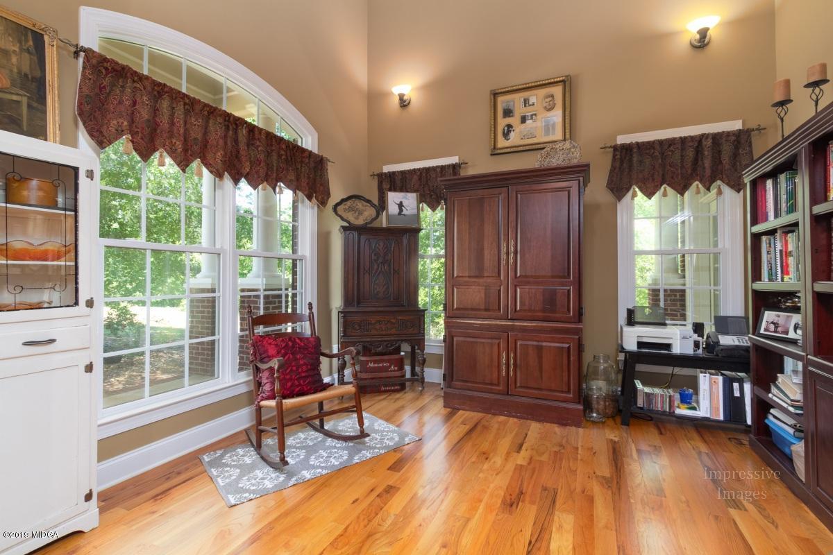 800 Pine Grove Church Road Culloden, GA 31016 - Photo 5 of 30 a living room with furniture a rug and a large window