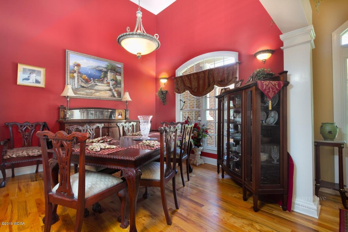 800 Pine Grove Church Road Culloden, GA 31016 - Photo 6 of 30 a view of a dining room with furniture and chandelier