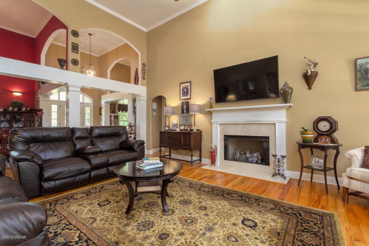 800 Pine Grove Church Road Culloden, GA 31016 - Photo 8 of 30 a living room with furniture a flat screen tv and a fireplace