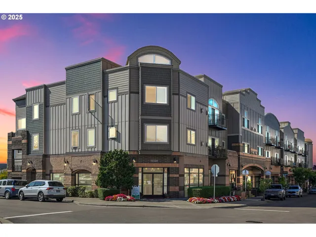 a front view of a residential apartment building with a yard