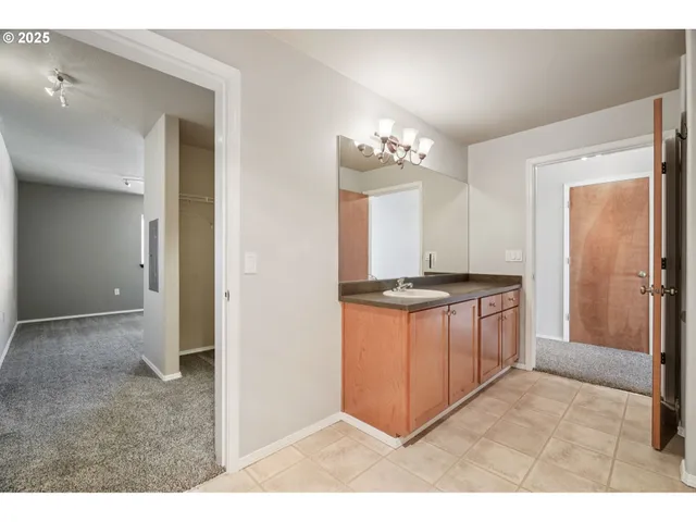 a kitchen with granite countertop a refrigerator and a sink