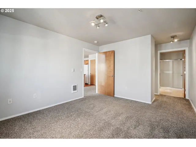 a view of an empty room with a bathroom