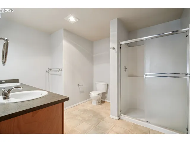 a bathroom with a sink vanity mirror and toilet