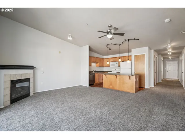 a view of a kitchen with a sink and a fireplace