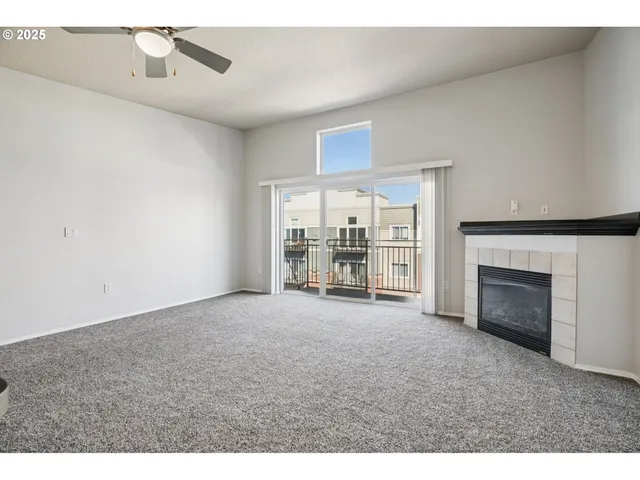 a view of empty room with a fireplace