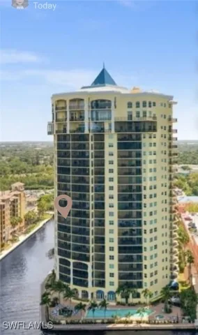 a front view of a building with lake view and tall buildings