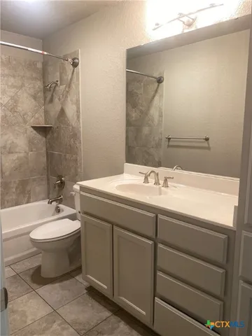a bathroom with a double vanity sink toilet mirror and bathtub