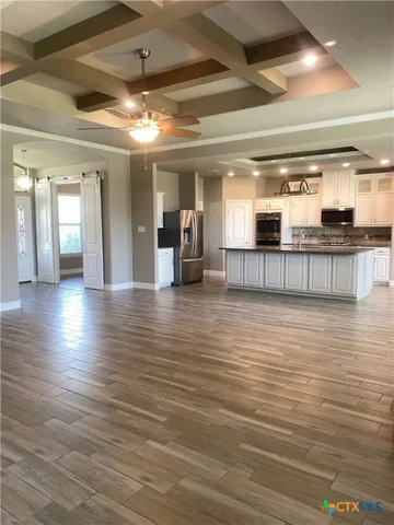 a room with lots of wooden furniture and chandelier
