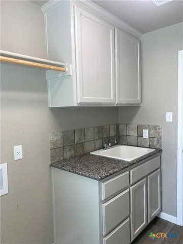 a kitchen with a sink and cabinets