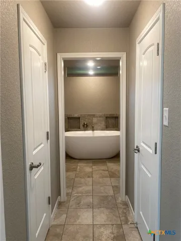 a bathroom with a bathtub and shower