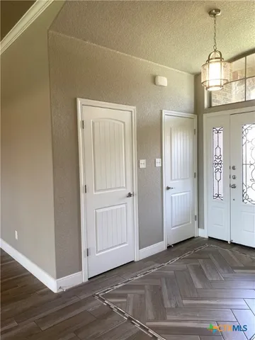 a view of a room with wooden floor and window