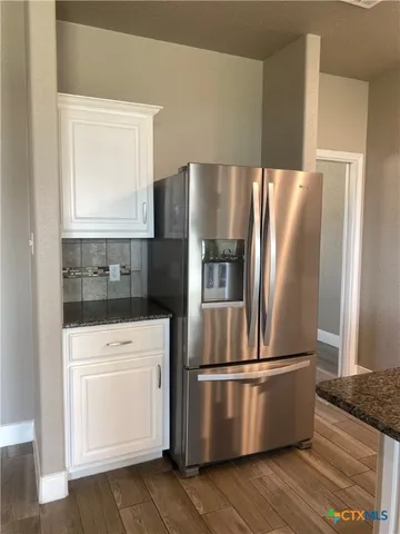 a kitchen with stainless steel appliances a refrigerator and a stove