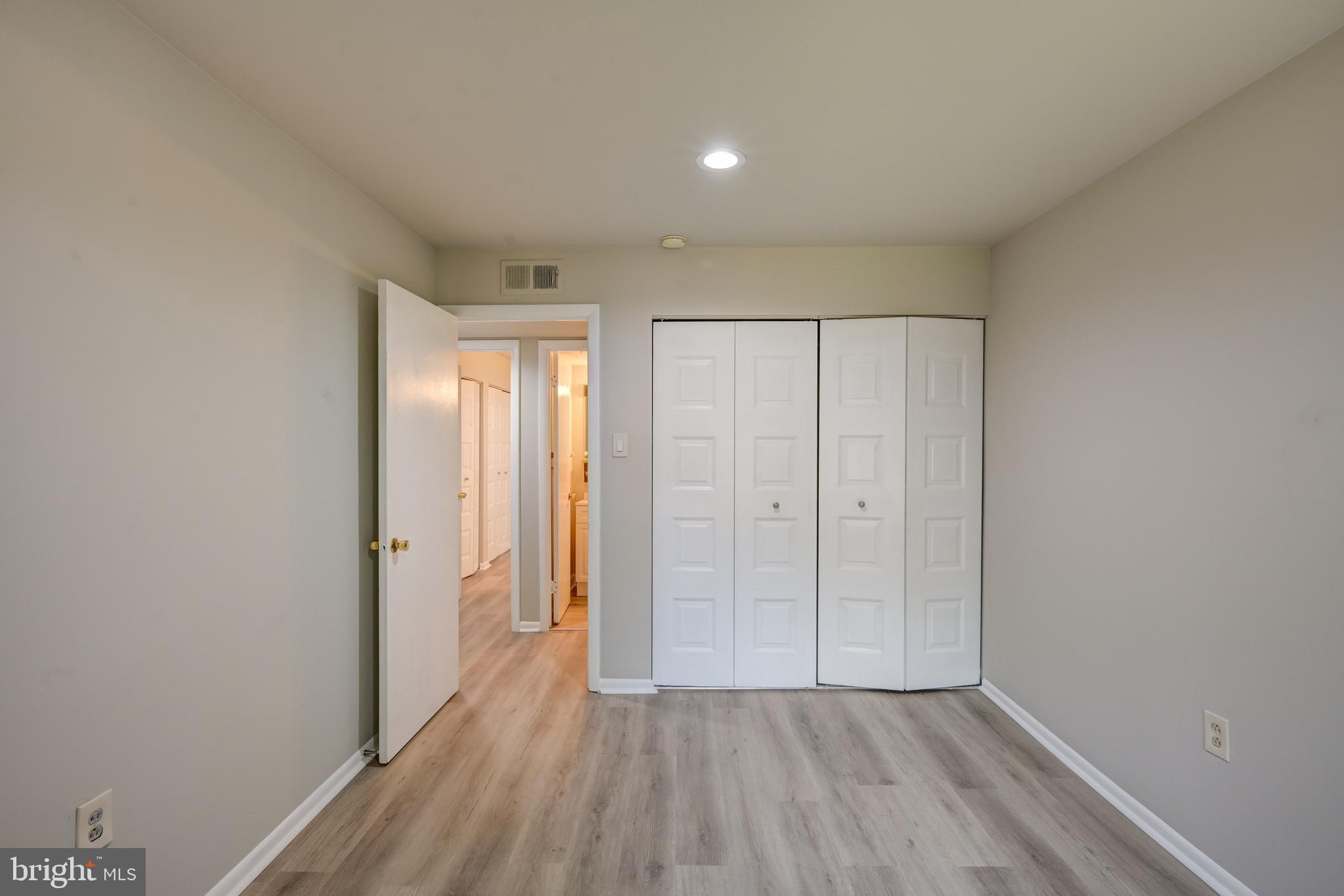 5241 West Running Brook Road, Unit 302 Columbia, MD 21044 - Photo 12 of 32 a view of an empty room with wooden floor