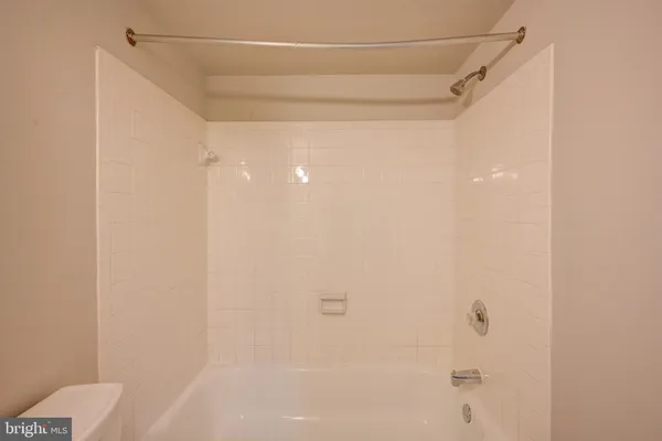 a bathroom with a shower and a toilet