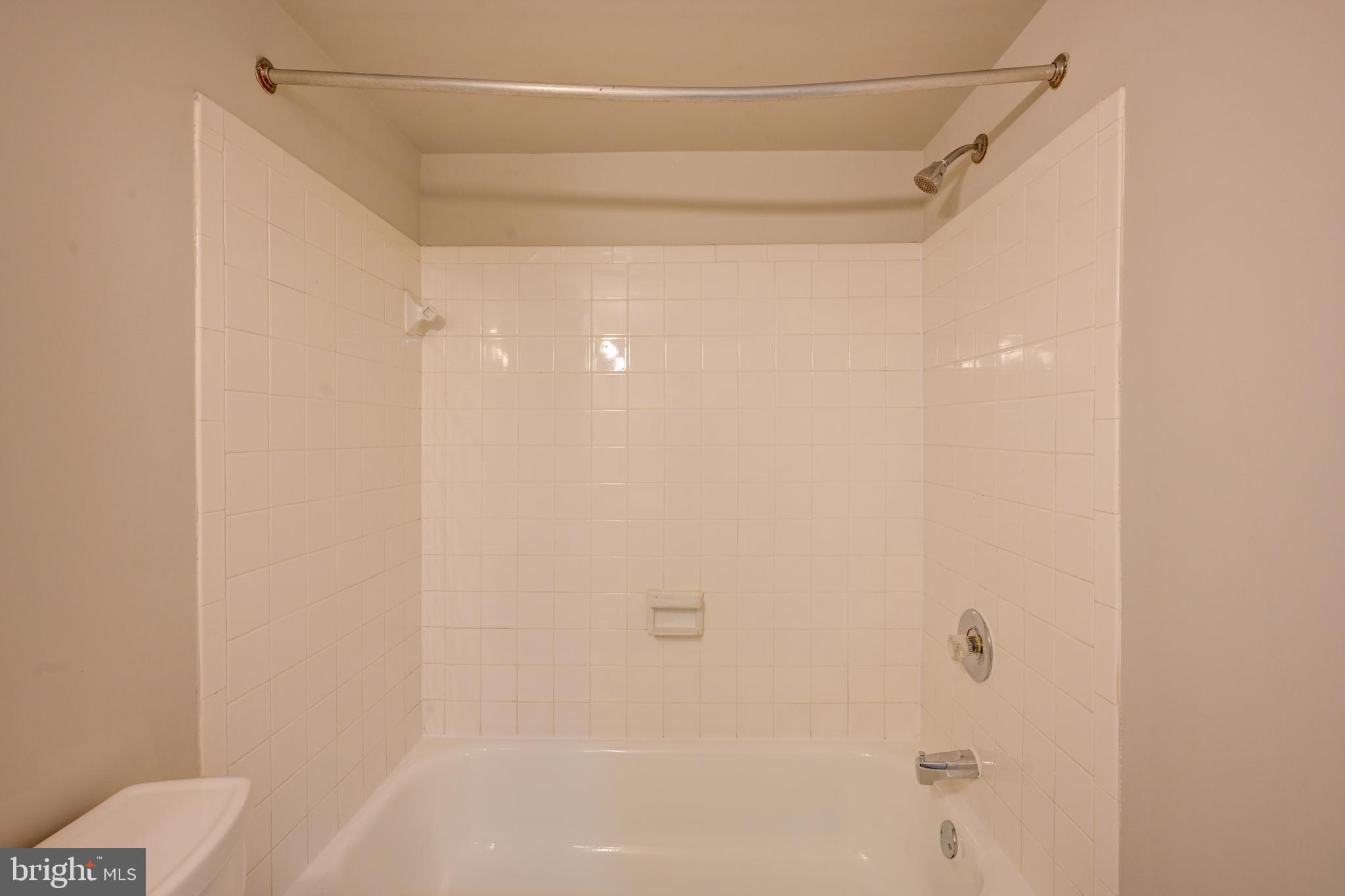 5241 West Running Brook Road, Unit 302 Columbia, MD 21044 - Photo 13 of 32 a bathroom with a shower and a toilet
