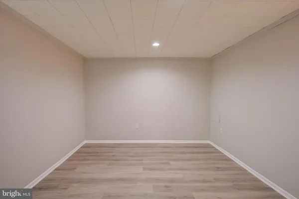 a view of room with wooden floor