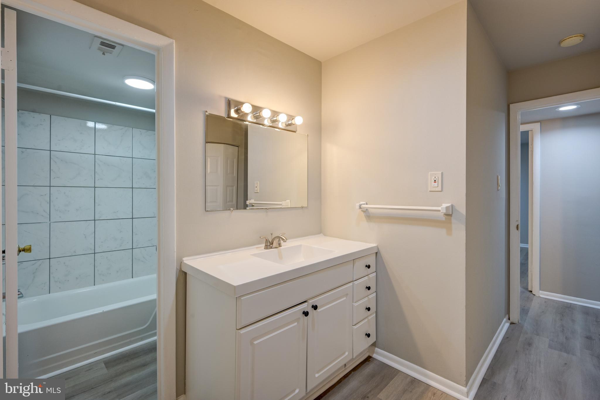 5241 West Running Brook Road, Unit 302 Columbia, MD 21044 - Photo 20 of 32 a bathroom with a sink a toilet and shower