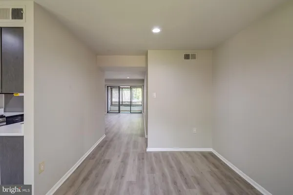 a view of hallway with wooden floor