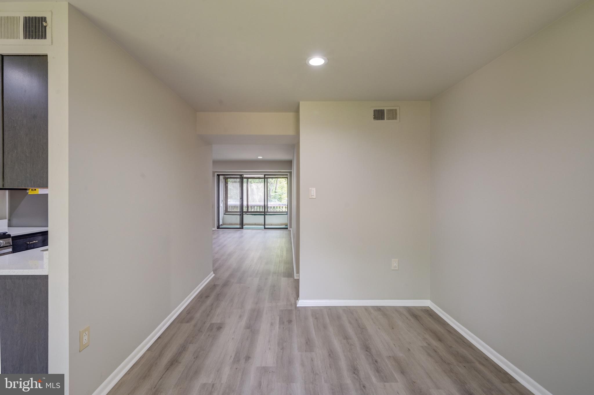 5241 West Running Brook Road, Unit 302 Columbia, MD 21044 - Photo 23 of 32 a view of hallway with wooden floor