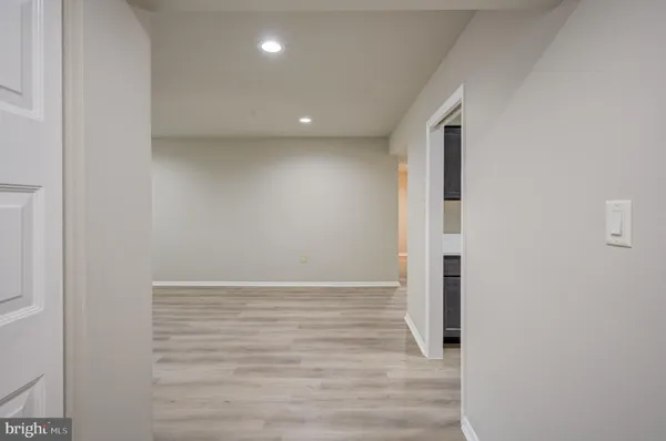 a view of hallway with wooden floor