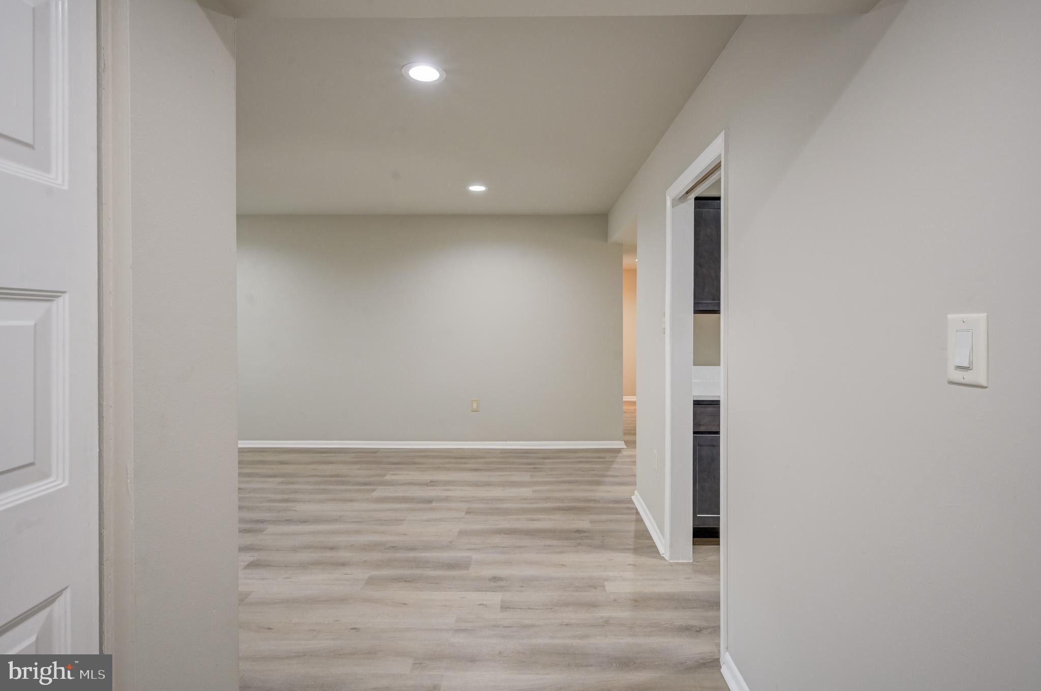 5241 West Running Brook Road, Unit 302 Columbia, MD 21044 - Photo 25 of 32 a view of hallway with wooden floor