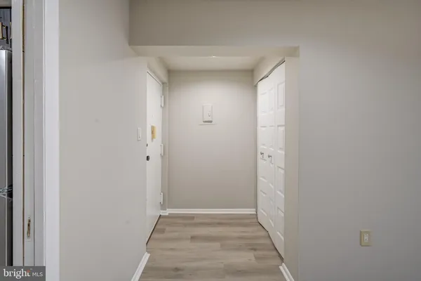 a view of hallway with closet area
