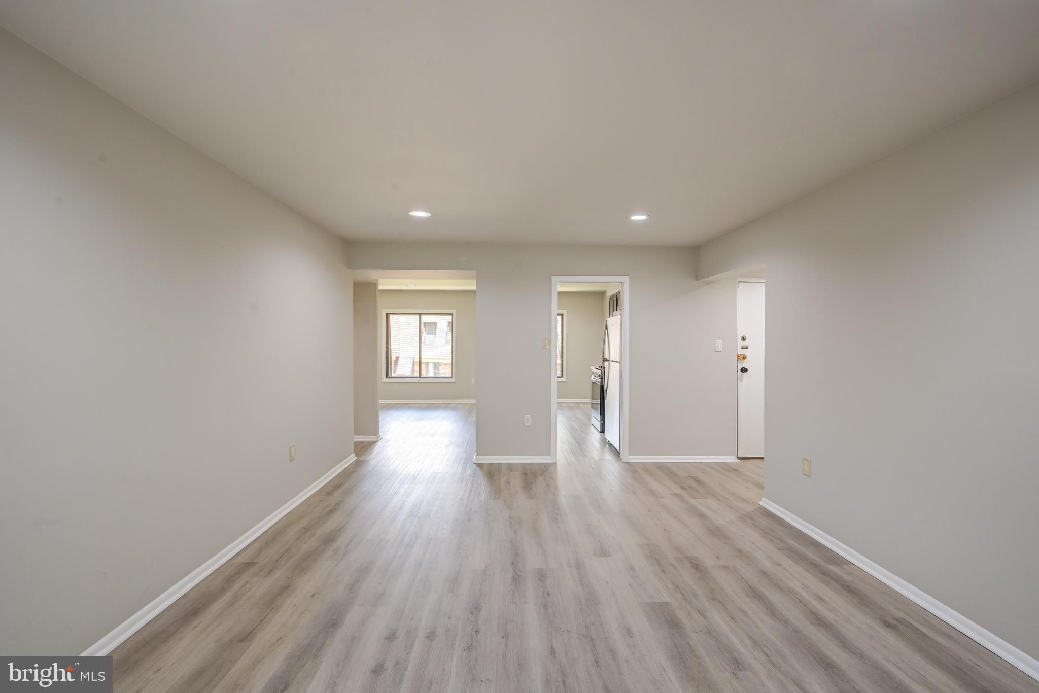 5241 West Running Brook Road, Unit 302 Columbia, MD 21044 - Photo 3 of 32 wooden floor in an empty room with a window