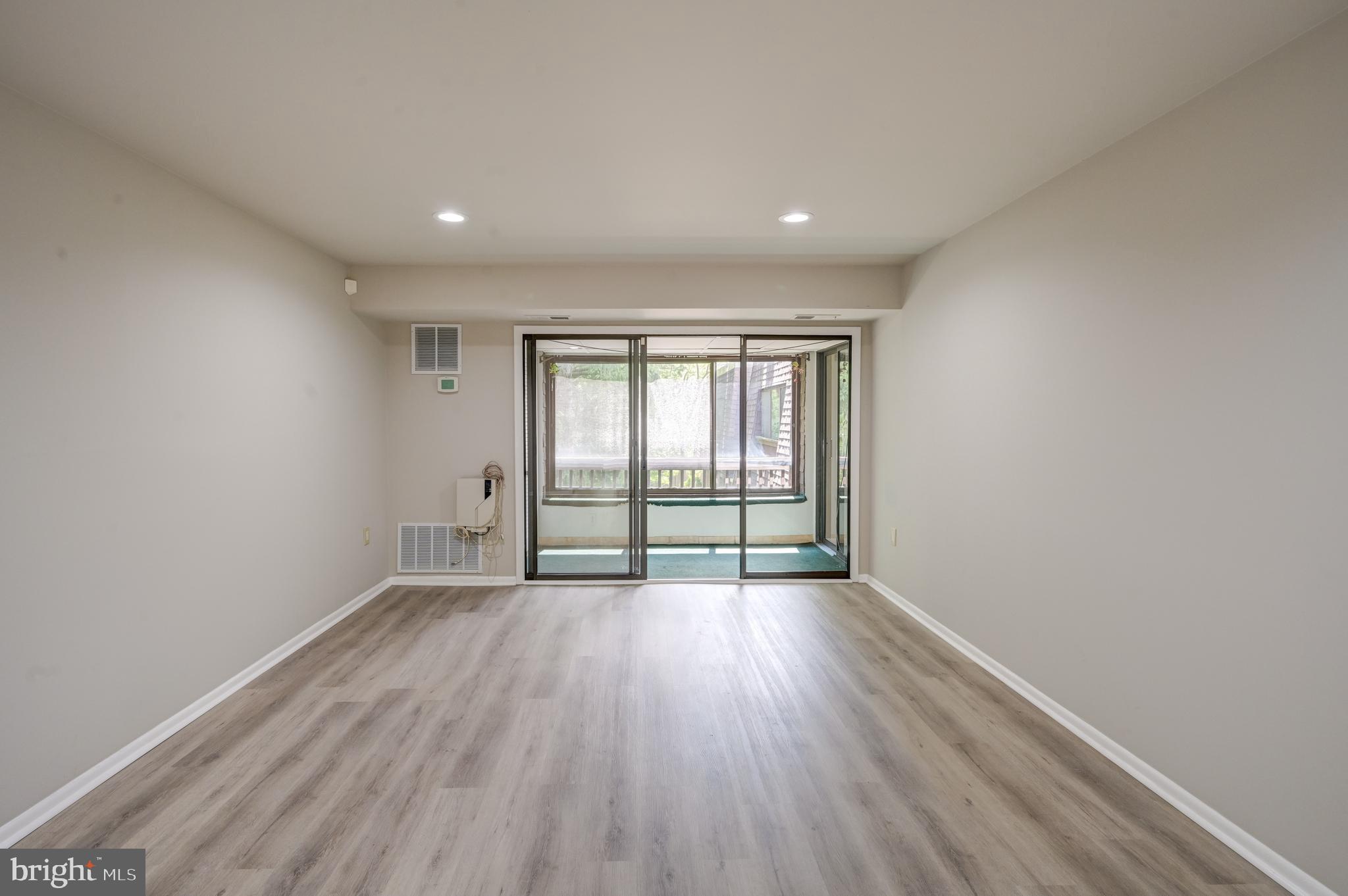 5241 West Running Brook Road, Unit 302 Columbia, MD 21044 - Photo 4 of 32 wooden floor in an empty room with a window