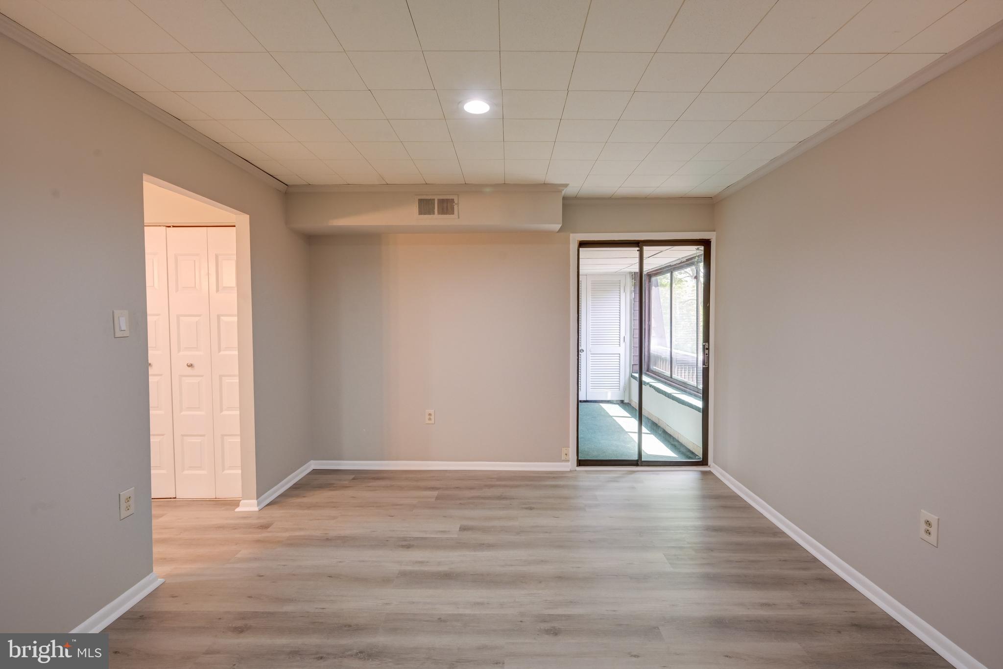 5241 West Running Brook Road, Unit 302 Columbia, MD 21044 - Photo 5 of 32 wooden floor in an empty room with a window