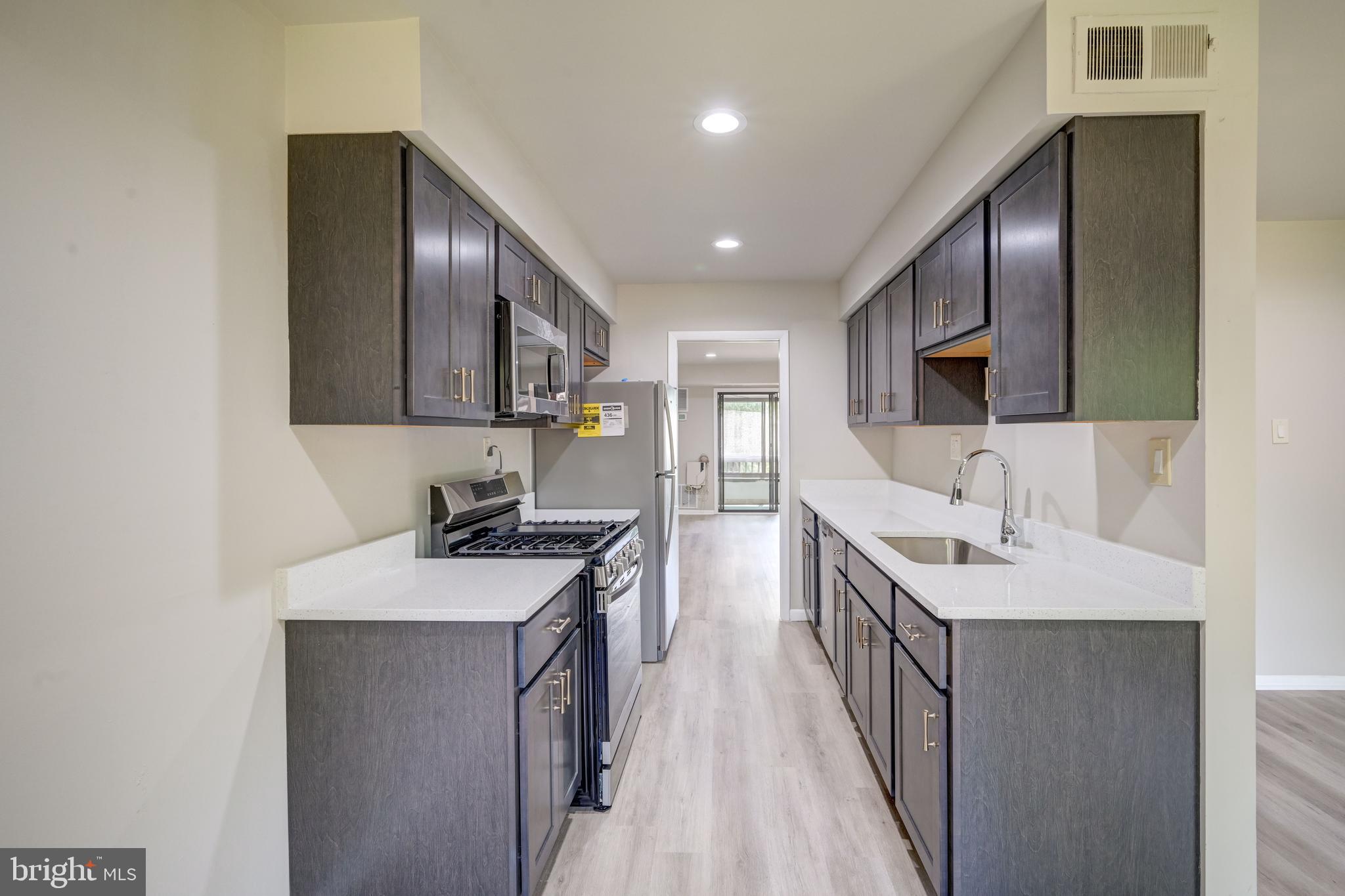 5241 West Running Brook Road, Unit 302 Columbia, MD 21044 - Photo 9 of 32 a kitchen with a sink appliances and cabinets