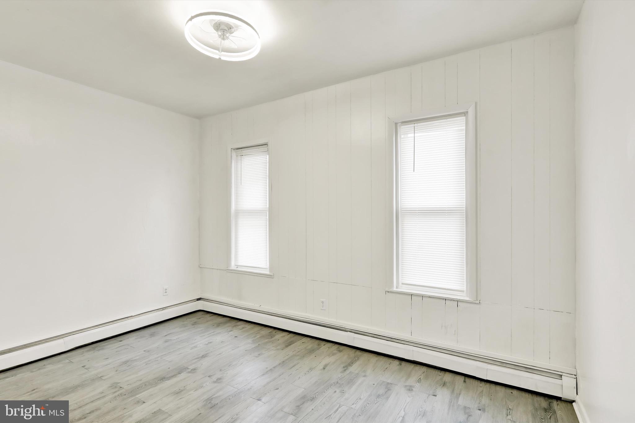 236 Wunder Street Reading, PA 19602 - Photo 15 of 27 an empty room with wooden floor and windows