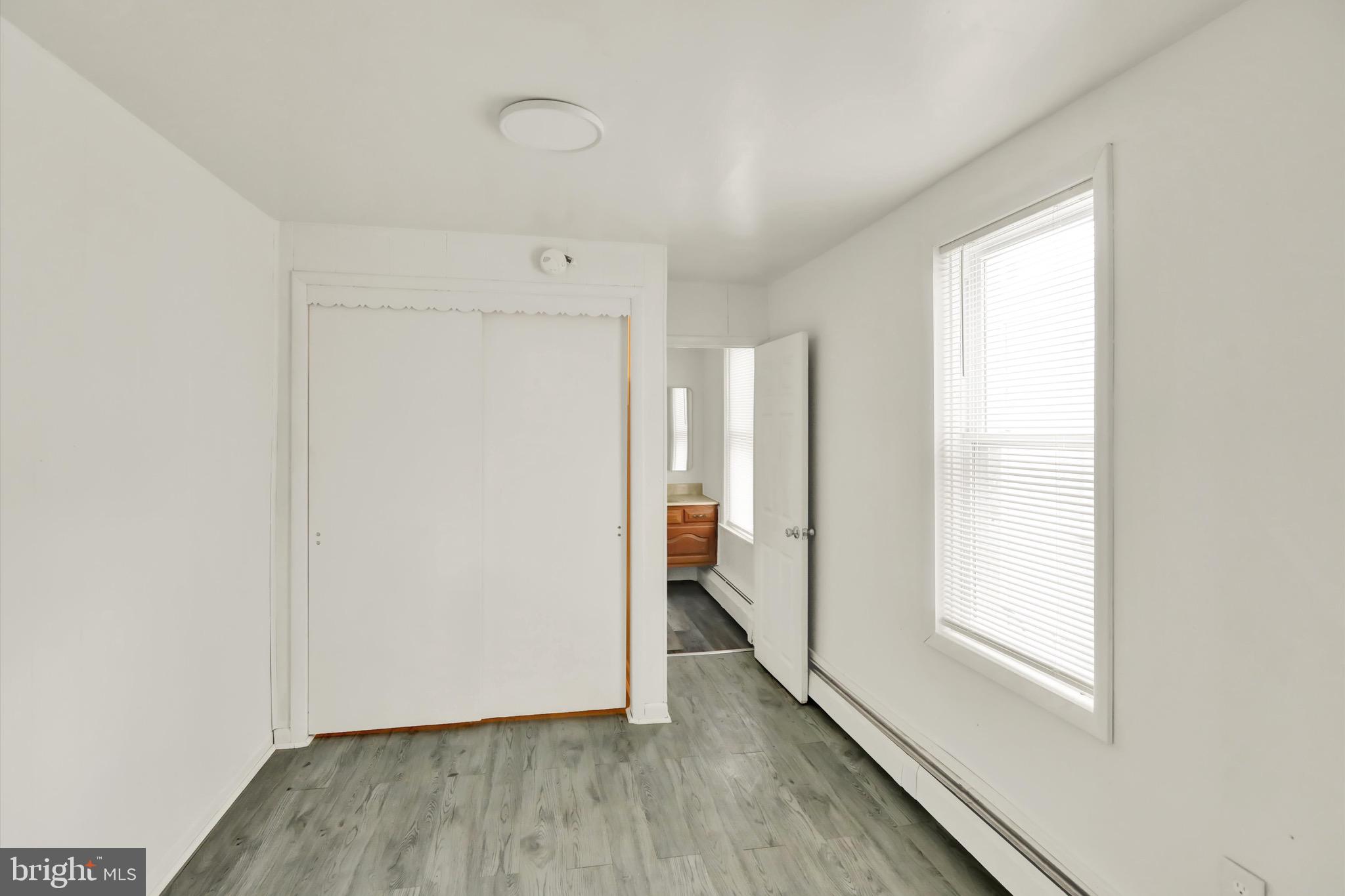 236 Wunder Street Reading, PA 19602 - Photo 16 of 27 a view of an empty room with wooden floor and a window