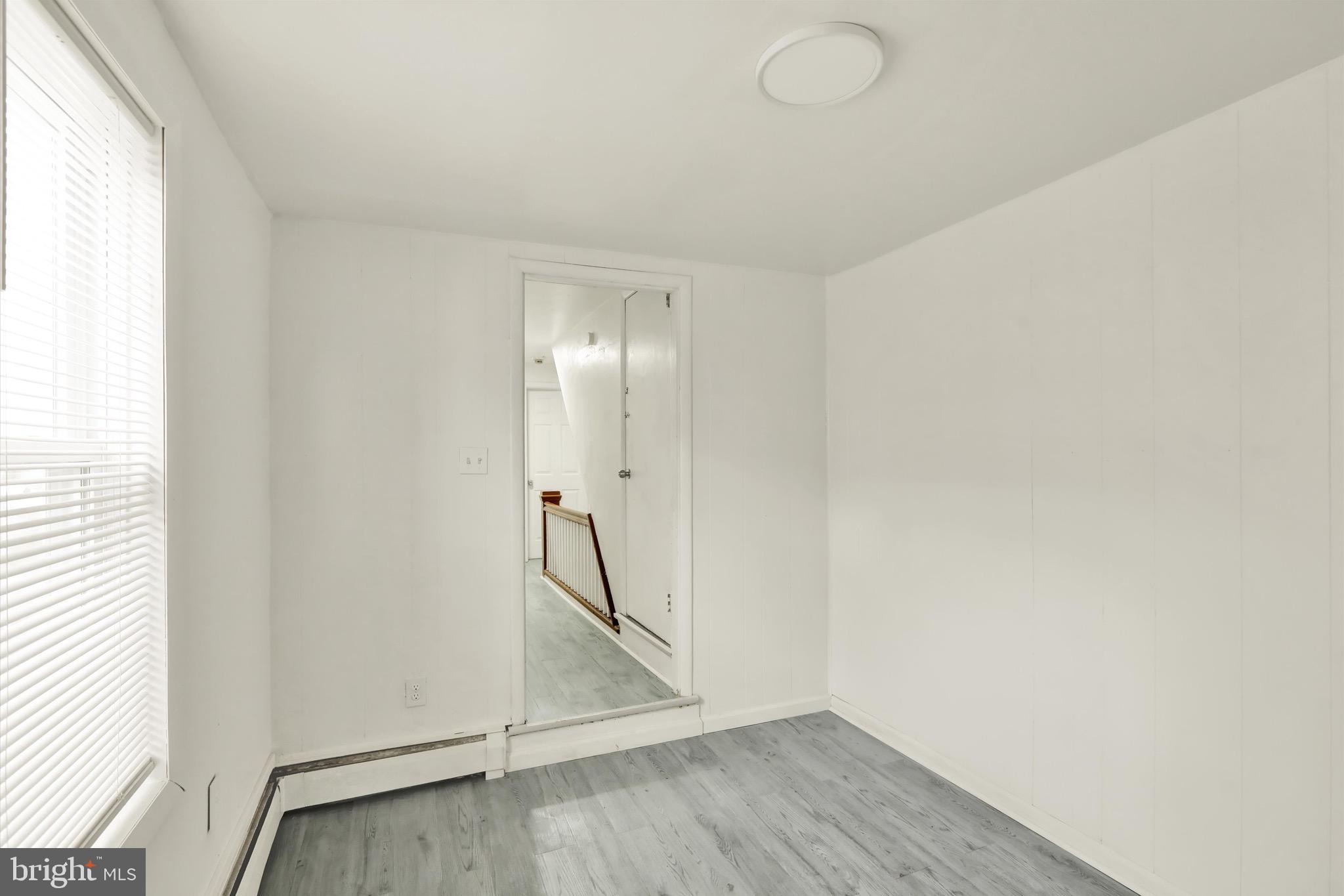 236 Wunder Street Reading, PA 19602 - Photo 17 of 27 an empty room with wooden floor and windows