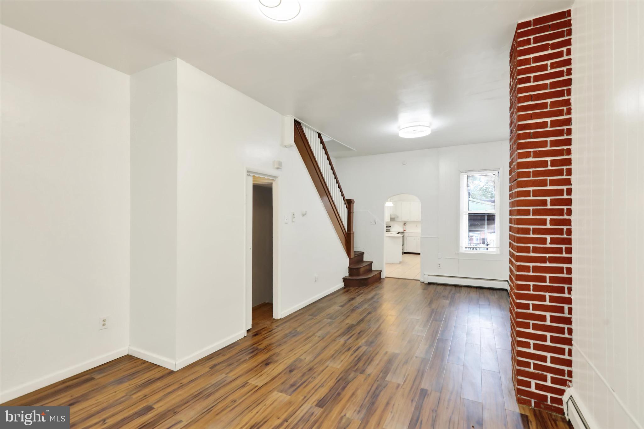 236 Wunder Street Reading, PA 19602 - Photo 6 of 27 a view of an empty room with wooden floor and stairs