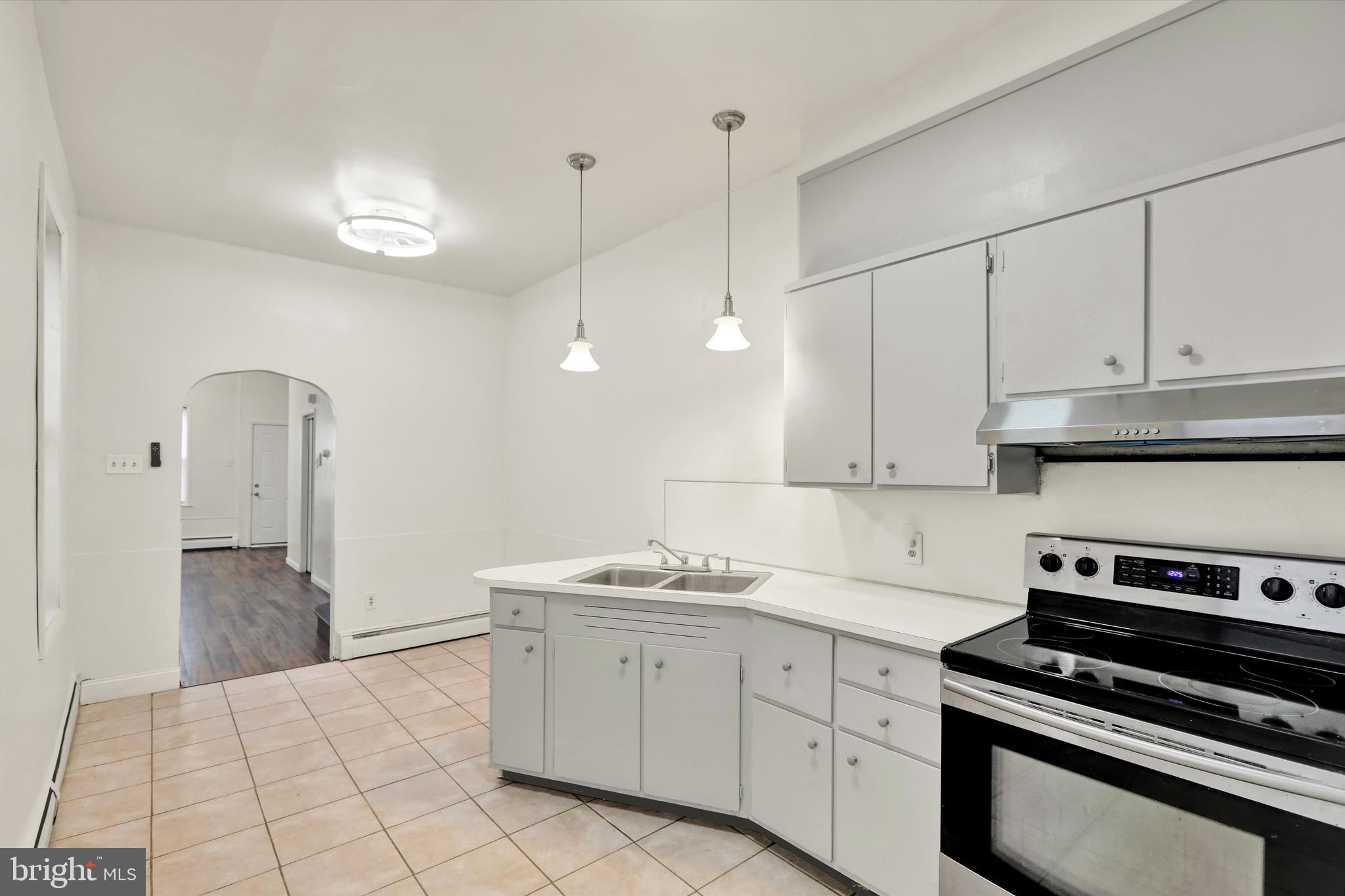 236 Wunder Street Reading, PA 19602 - Photo 7 of 27 a kitchen with white cabinets and appliances