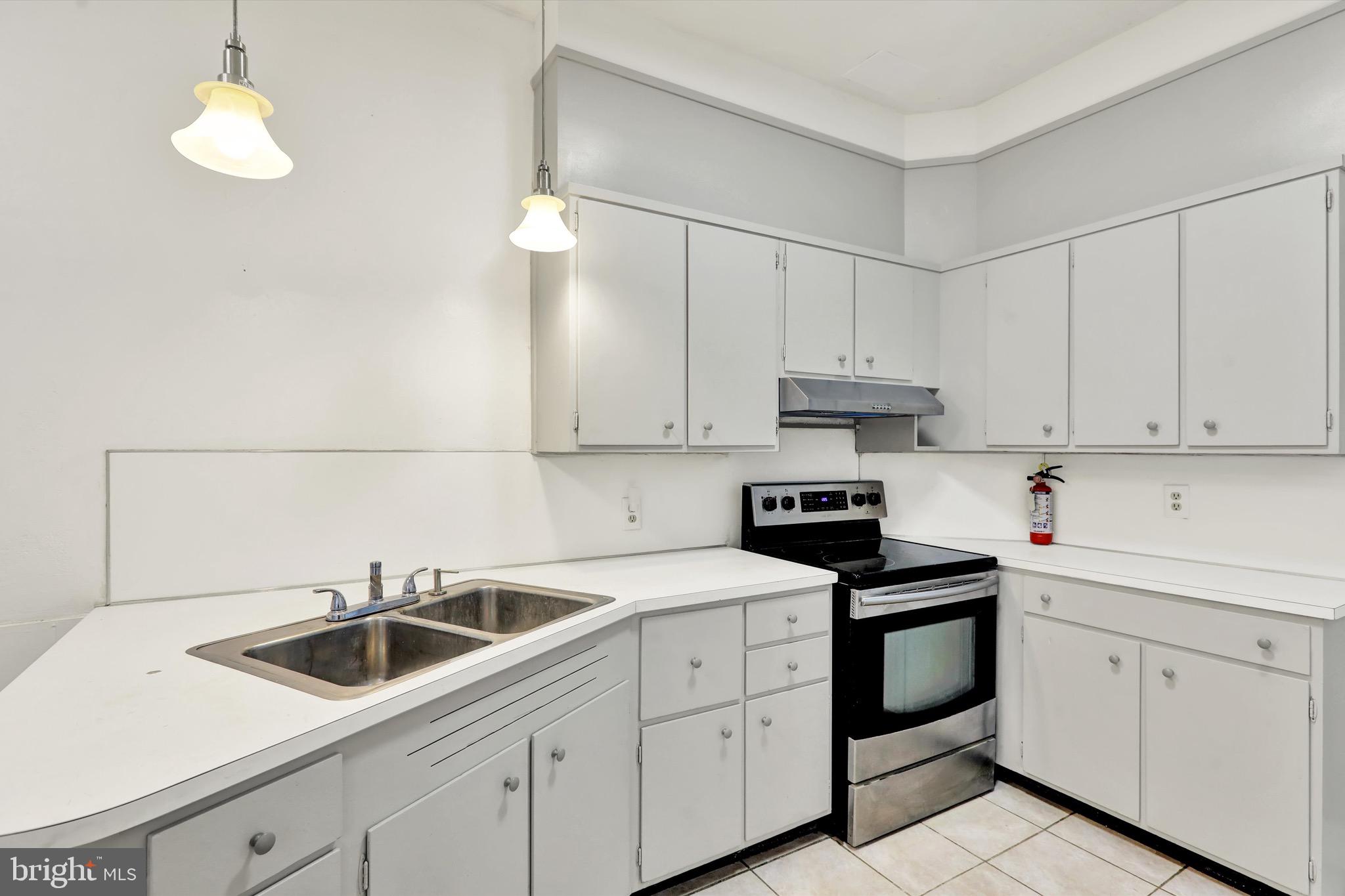 236 Wunder Street Reading, PA 19602 - Photo 8 of 27 a kitchen with white cabinets and white appliances