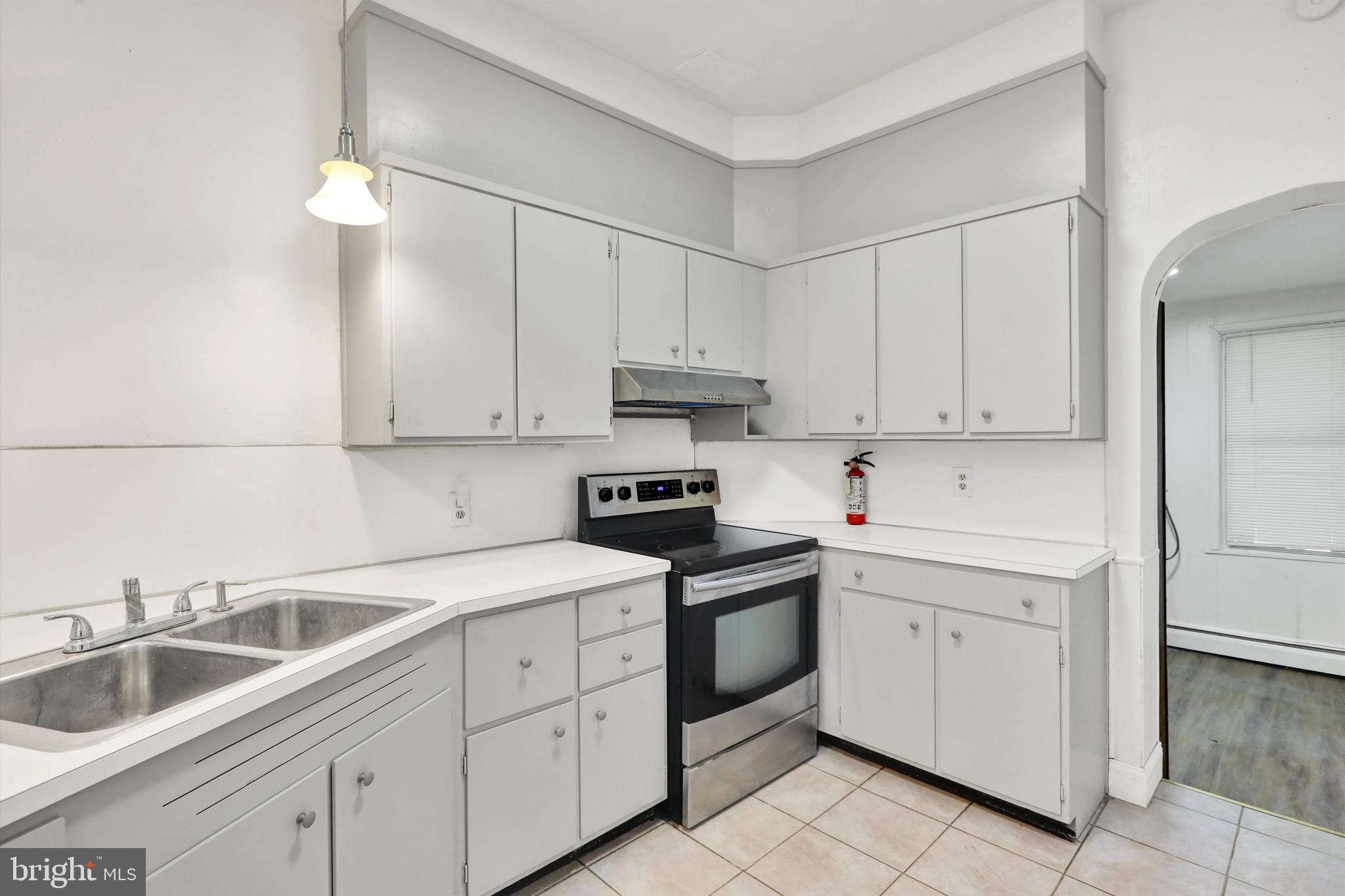 236 Wunder Street Reading, PA 19602 - Photo 9 of 27 a kitchen with white cabinets sink and appliances