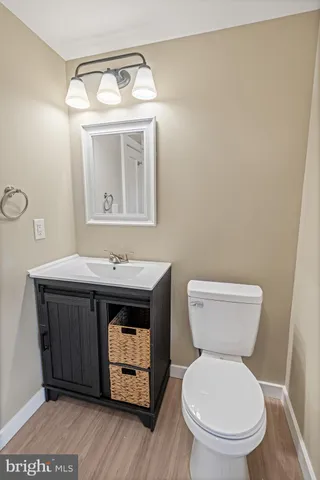 a bathroom with a toilet a sink and mirror