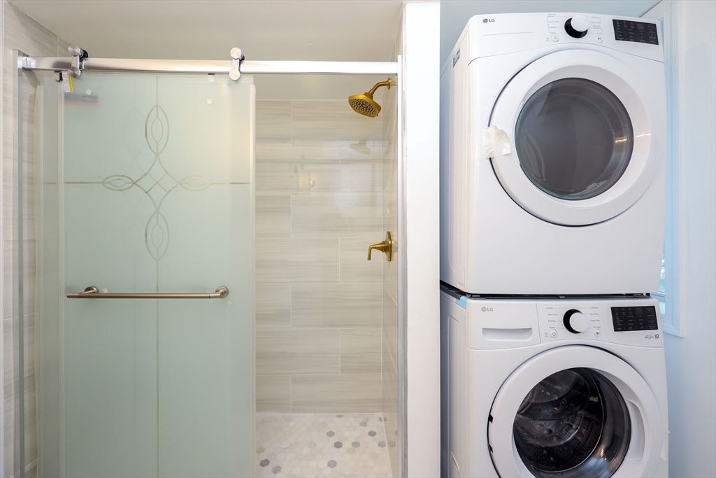 5 Chauncy Street, Unit 3 Cambridge, MA 02138 - Photo 6 of 11 a view of a hallway with washer and dryer